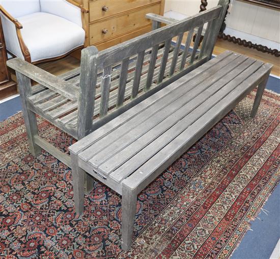 A teak garden seat and a similar bench Seat L.124cm, Bench L.152cm